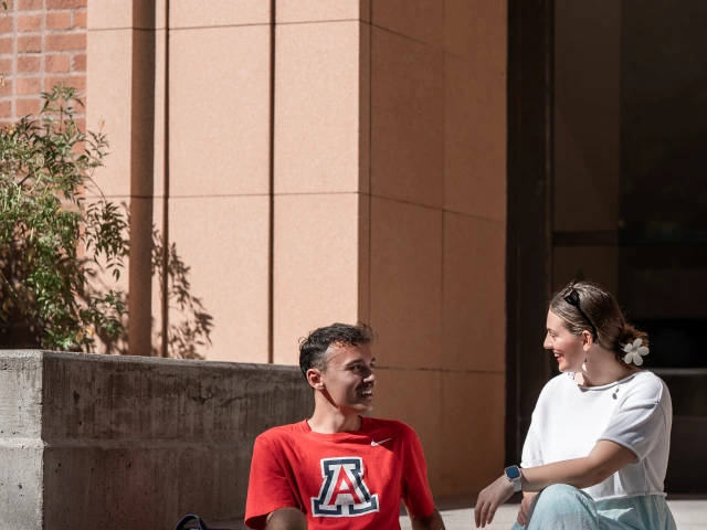two people sitting on outdoor stairs